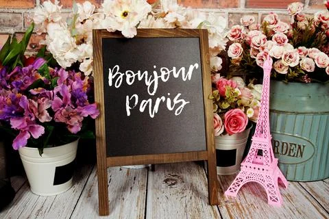 Bonjour Paris text message write on chalkboard with pink Eiffel tower souve.. Stock Photos