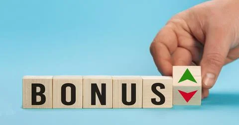 Bonus is going up or vice down. Hand is turning wooden cubes a dice and changes Stock Photos