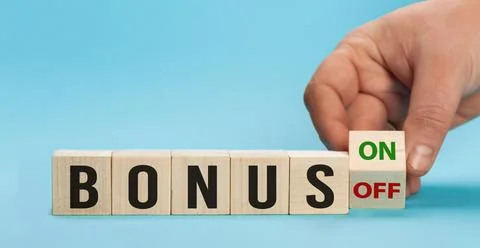 Bonus is going up or vice down. Hand is turning wooden cubes a dice and changes Stock Photos