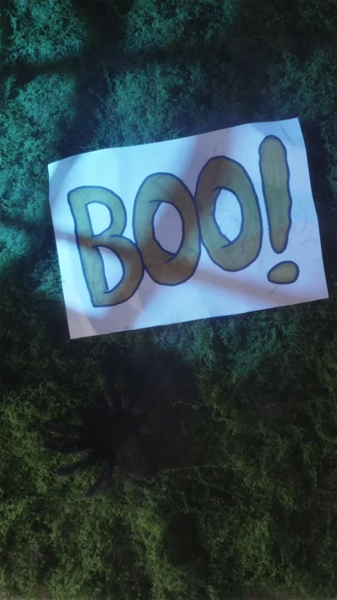 BOO graphic text popping into frame over smoky moss Stockbeeldmateriaal 342423083