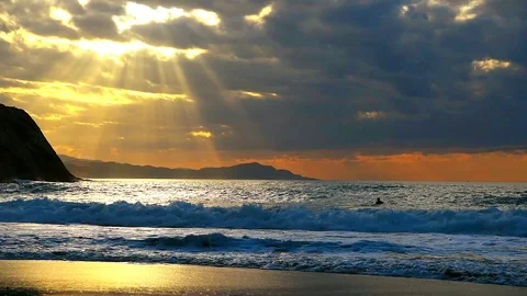 Boogie boarder flips in ocean wave at sunset. Stock Footage 119568986