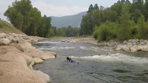 Boogie boarding on a rivers wave. Stock Footage 93384099