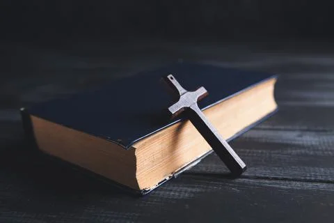 Book and cross on the table Stock Photos