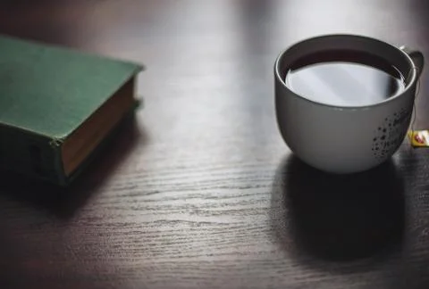 Book and cup of tea on  the table Stock Photos