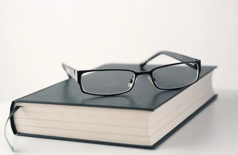 Book and glasses Stock Photos