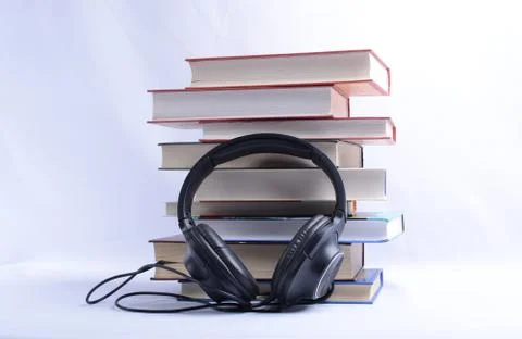 Book and headphones. concept of audiobooks and education Stock Photos