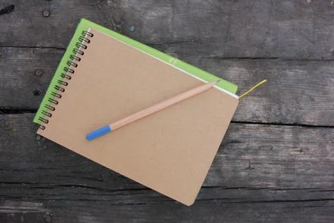 Book and notepad on rustic textured background outdoors Stock-Fotos