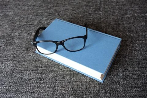 Book and a pair of glasses Stock Photos