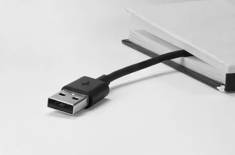 Book and usb cable Stock Photos
