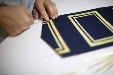 Book binder hand working a pattern Stock Photos