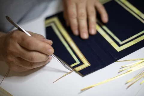 Book binder hand working a pattern Stock Photos