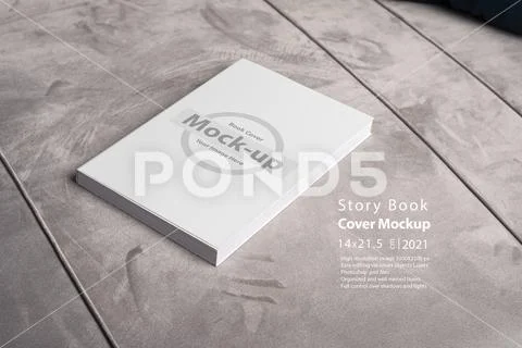 Book with blank cover on gray velvet sofa backdrop mock-up series PSD Template
