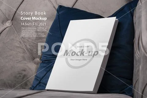Book with blank cover on velvet sofa blue cushion mock-up series PSD-sjabloon