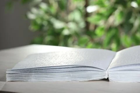 Book with Braille text on table, closeup. Education and leisure for blind p.. 写真素材