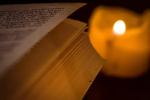 Book by candlelight Stock Photos