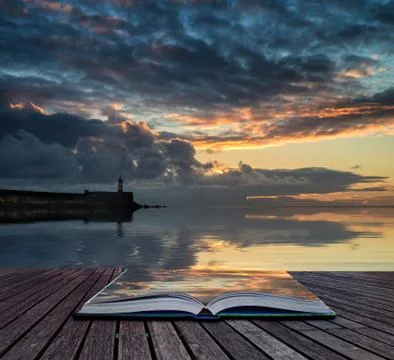 Book concept beautiful vibrant sunrise sky over calm water ocean with lightho Ilustración de archivo
