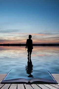 Book concept concept image of young boy walking on water in sunset landscape Illustrazione stock
