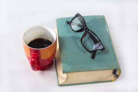 Book with cup Stock Photos