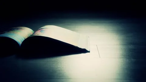 Book in a dark room on the floor Stock Footage 40524209