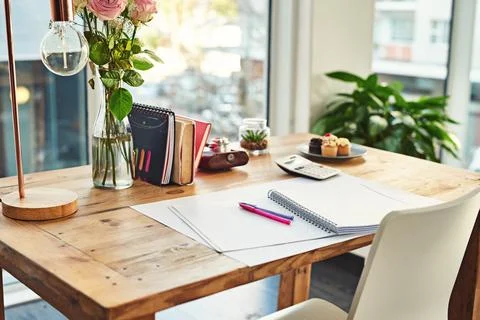 Book, desk and remote work in creative empty workplace with paper for writing Stock Photos