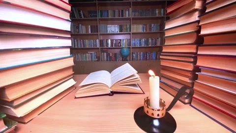 Book on desk in library at candle burning, wind Stock Footage 255025628