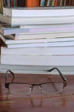 Book with eyeglasses Stock Photos