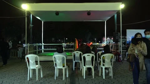 A book fair preparing a small concert at night with people wearing a mask Видео 160377945