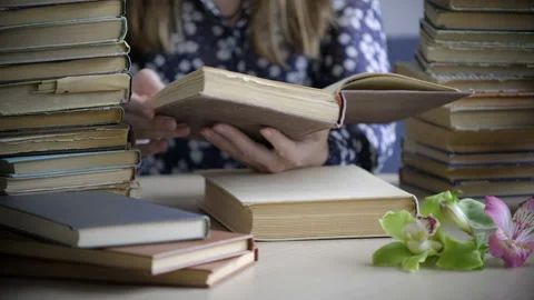 Book. Female hands leaf over the pages of old book in library Stock Footage 159395817