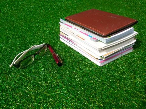 Book on grass Stock Photos