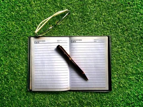 Book on grass Stock Photos