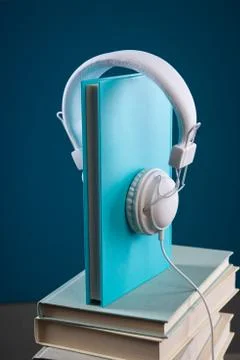 Book with headphones Stock Photos