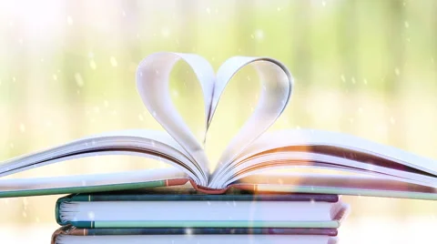 Book in heart shape, wind and falling snow. Stock Footage 61919623