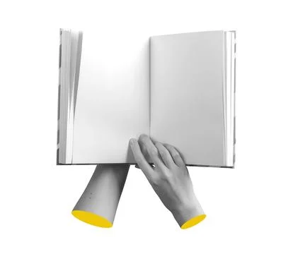 Book is held open by a hand, showing an empty spread. The pages are clear and Stock Photos