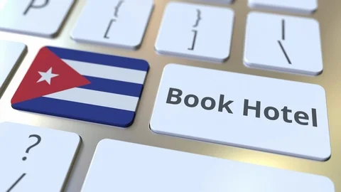 BOOK HOTEL text and flag of Cuba on the buttons on the computer keyboard. Travel Stock Footage 112463150