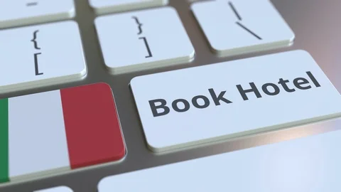 BOOK HOTEL text and flag of Italy on the buttons on the computer keyboard Stock Footage 112464975