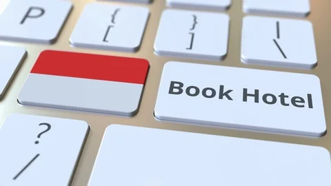 BOOK HOTEL text and flag of Indonesia on the buttons on the computer keyboard Stock Footage 112469803