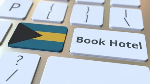 BOOK HOTEL text and flag of Bahamas on the buttons on the computer keyboard Stock Footage 112471067