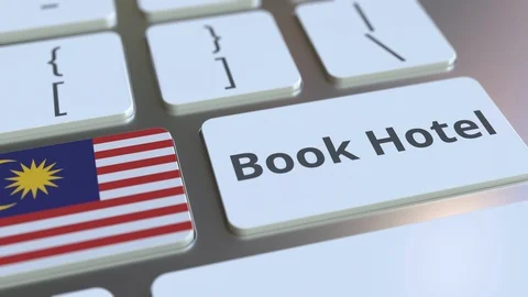 BOOK HOTEL text and flag of Malaysia on the buttons on the computer keyboard Stock Footage 112490437
