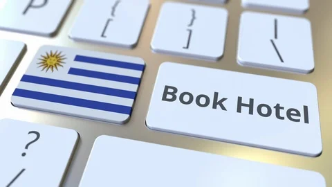 BOOK HOTEL text and flag of Uruguay on the buttons on the computer keyboard Stock Footage 112494935