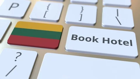 BOOK HOTEL text and flag of Lithuania on the buttons on the computer keyboard Stock Footage 112496423