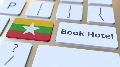 BOOK HOTEL text and flag of Myanmar on the buttons on the computer keyboard Stock Footage 112497260