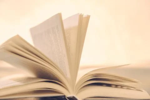 The book lies open on the table like magic in the Golden light Stock Photos