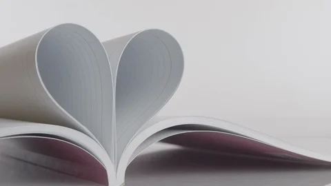 Book of love, the book page rolls into the heart - Valentine's day concept Stock Footage 122548219