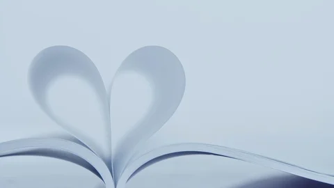 Book of love, the book page rolls into the heart - Valentine's day concept Stock Footage 122548367