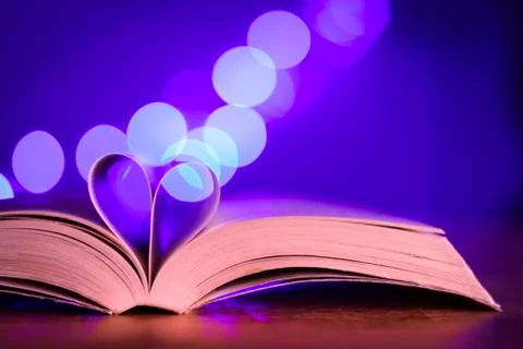 Book with low light and blue bokeh Stock Photos