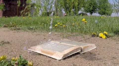 The book is lying on the ground. The wind turns the pages Stock Footage 50523147