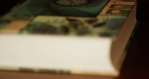 A book lying on a table, close up focus pull Stock Footage 150384129