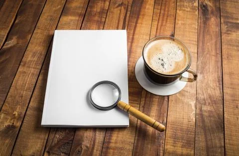 Book, magnifier, coffee cup Stock Photos