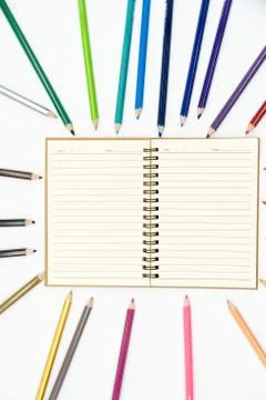 The book is in the middle between all 24 colors on a white background. Stock Photos