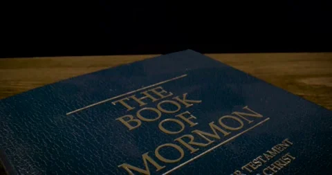 Book of Mormon Cover Macro Tilt Down Stock Footage 288229633